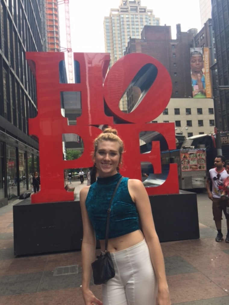 Sydney Walther posing next to LOVE sculpture in New York City.